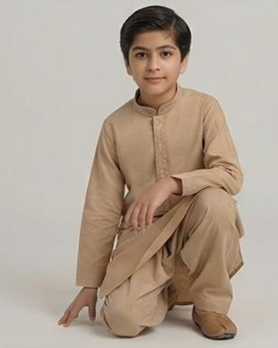 Boy wearing the beige winter shalwar kameez, kneeling