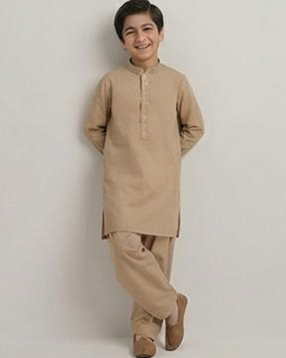 Boy wearing the beige winter shalwar kameez, standing